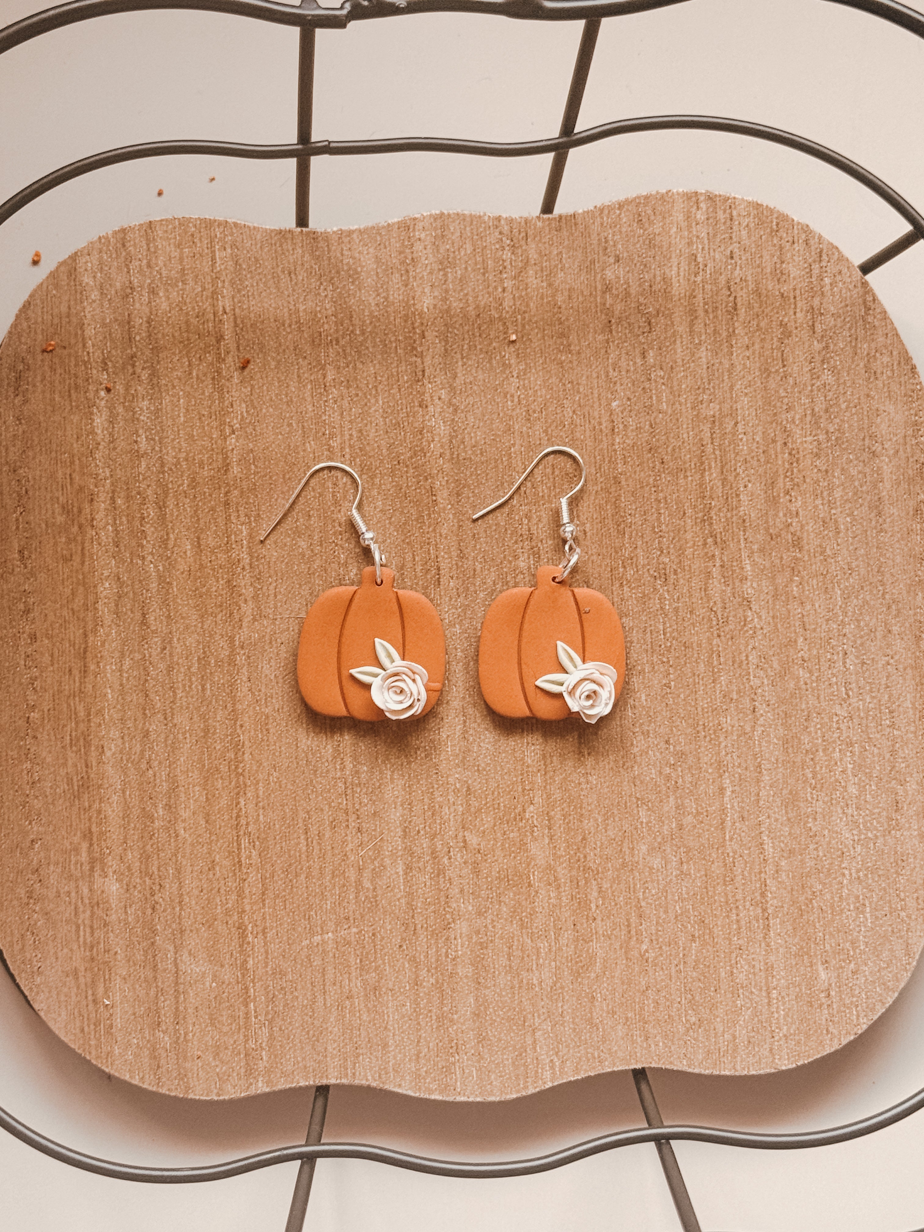 Pumpkins are orange, roses are white, Clay earrings are the best